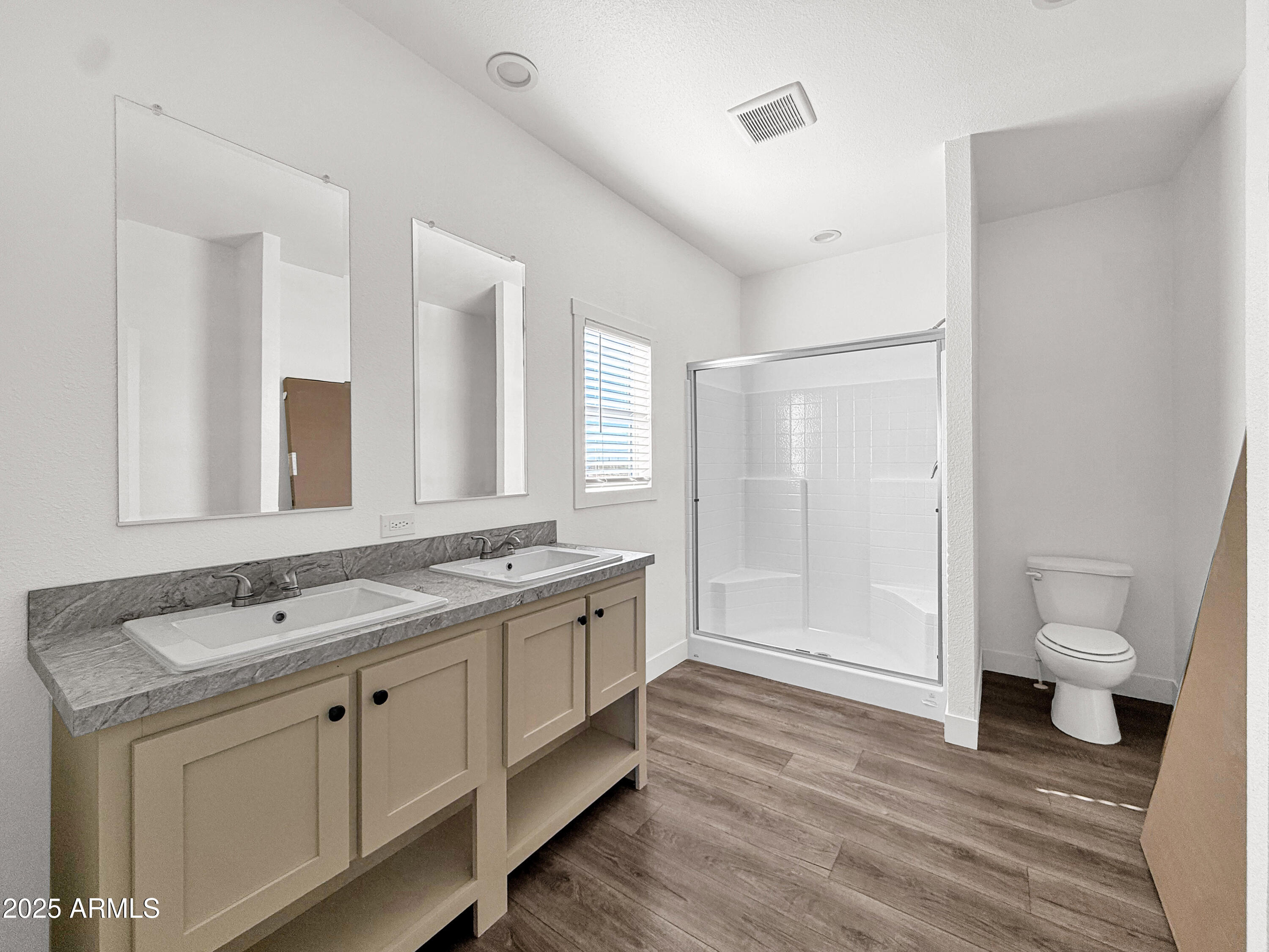 8548 North Page Road Florence, AZ 85132 - Photo 22 of 23 a spacious bathroom with a granite countertop toilet a double vanity sink a mirror and a shower