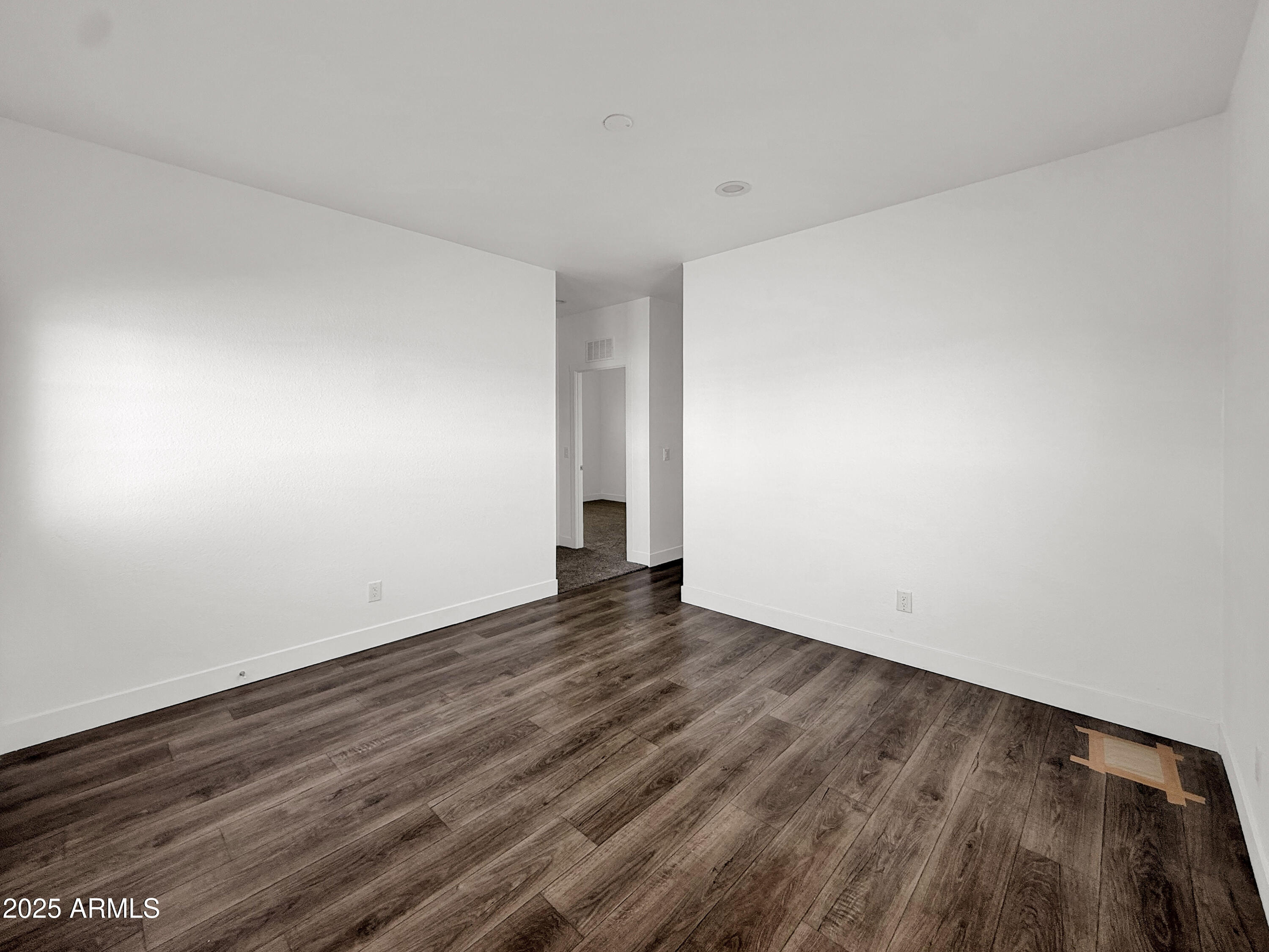 8548 North Page Road Florence, AZ 85132 - Photo 10 of 23 a view of an empty room with wooden floor