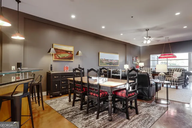 a living room with furniture kitchen view and a large window