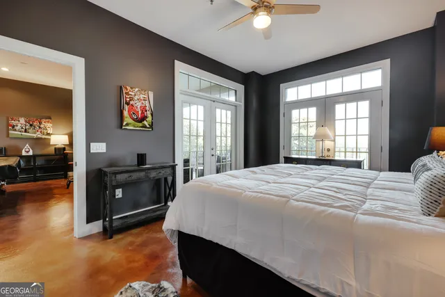 a bedroom with a bed and a chandelier