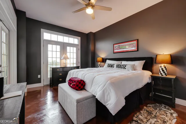a bedroom with a bed and wooden floor