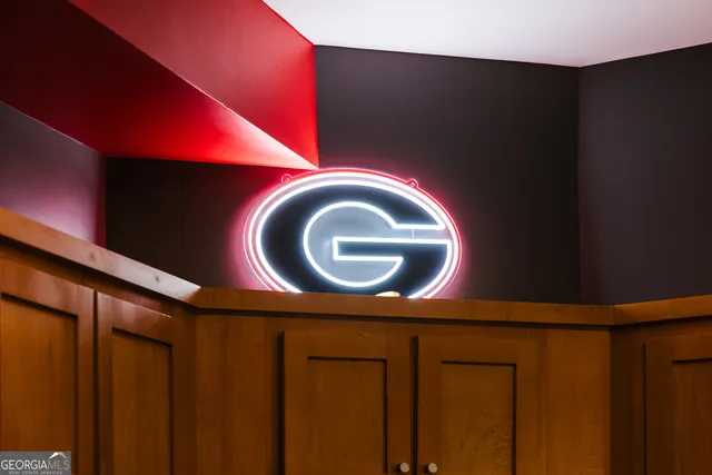 a kitchen with stainless steel appliances kitchen island granite countertop a dining table chairs and sink