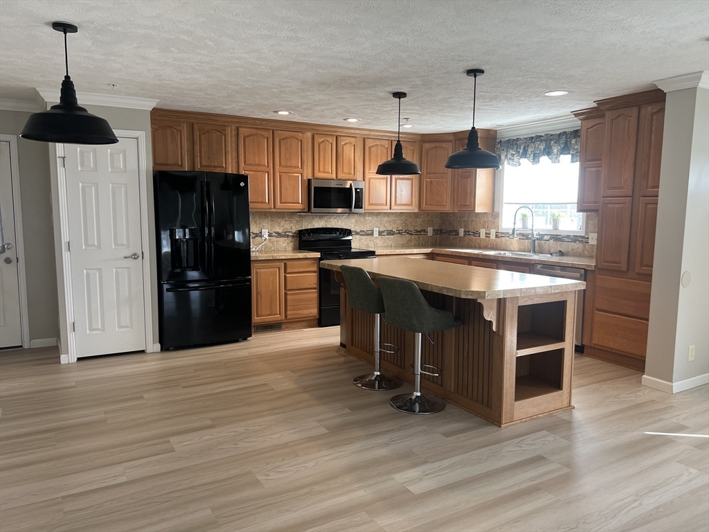 55 Hillview Drive West Springfield, MA 01089 - Photo 6 of 26 a kitchen with stainless steel appliances granite countertop a stove and a refrigerator