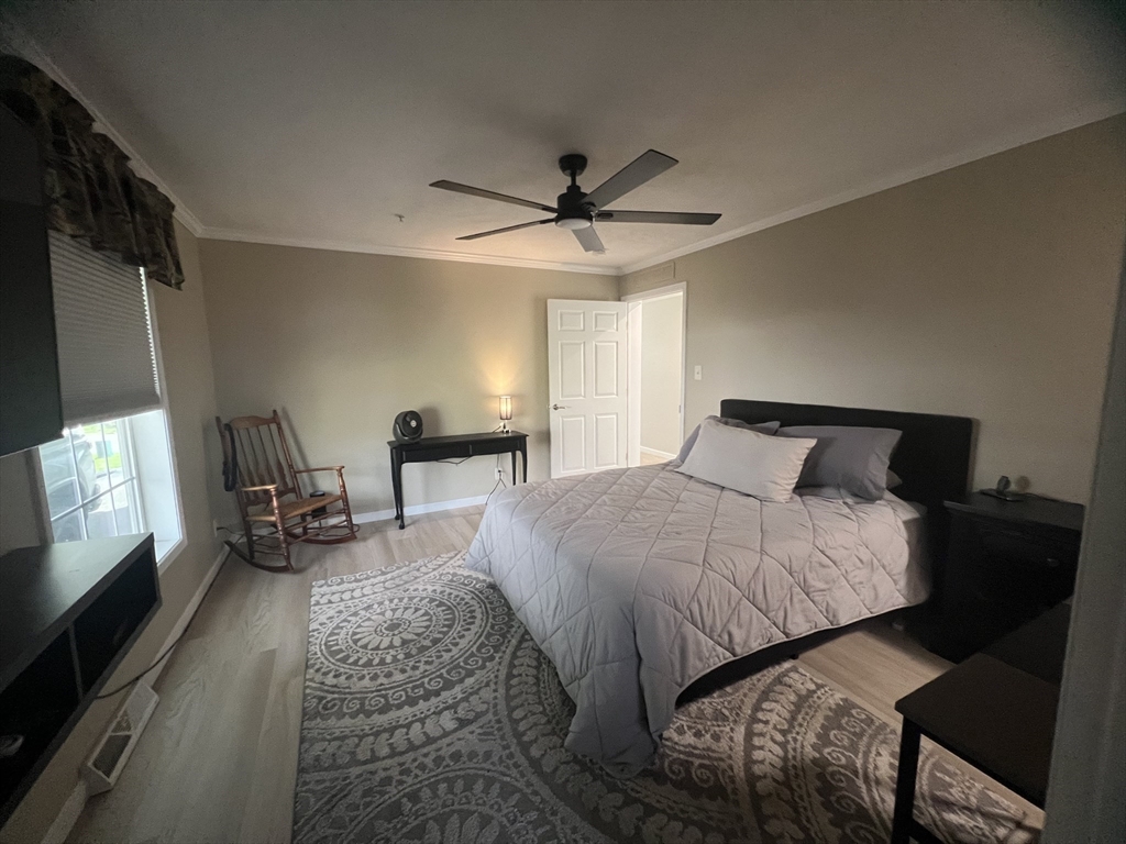 55 Hillview Drive West Springfield, MA 01089 - Photo 9 of 26 a bedroom with a bed a lamp and a flat screen tv