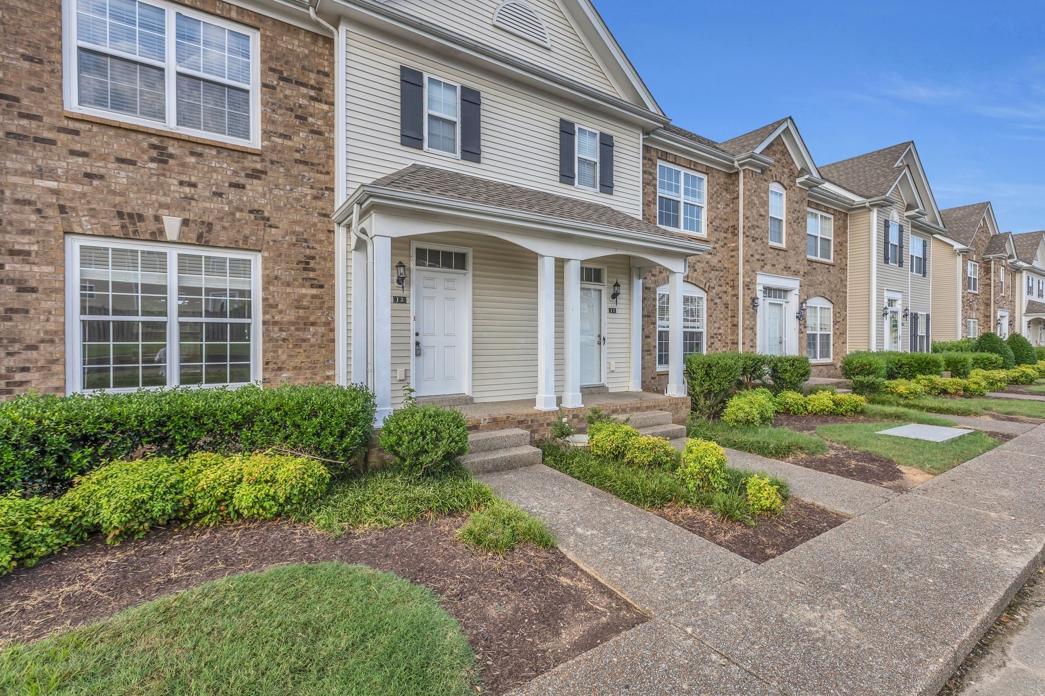 2271 Dewey Drive, Unit J3 Spring Hill, TN 37174 - Photo 2 of 31 a front view of a building with garden