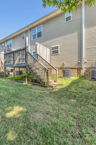 a view of house with backyard and porch