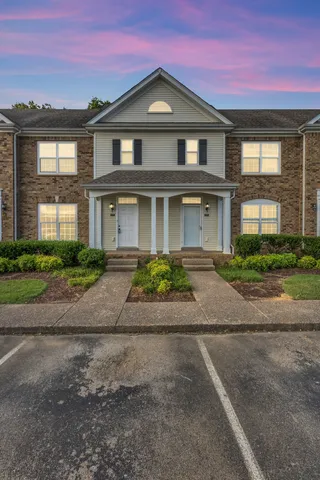 a front view of a house with a yard and a garage