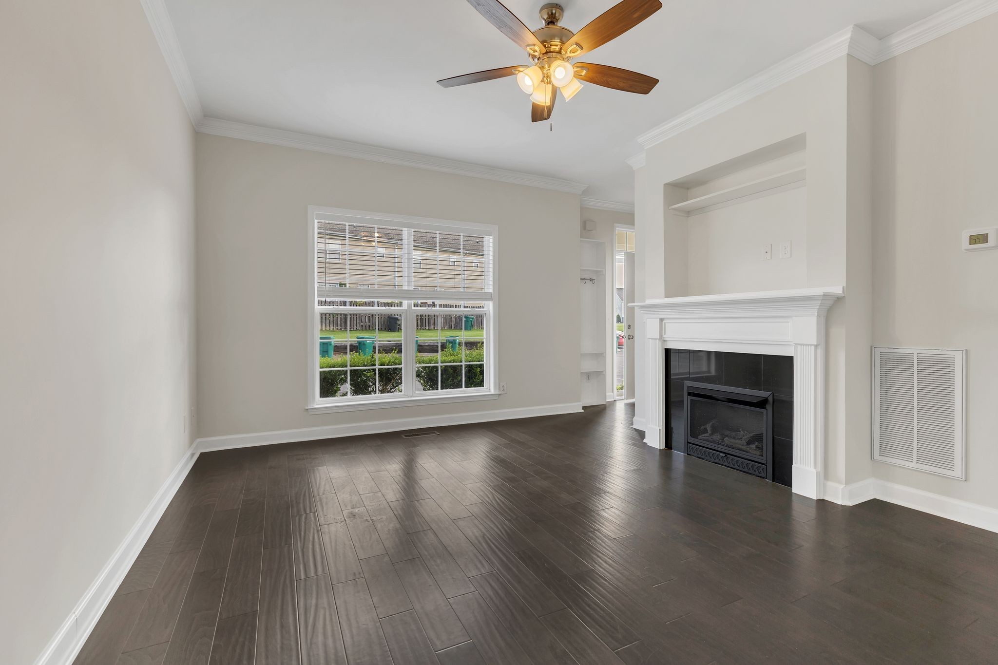2271 Dewey Drive, Unit J3 Spring Hill, TN 37174 - Photo 6 of 31 a view of an empty room with wooden floor and a window