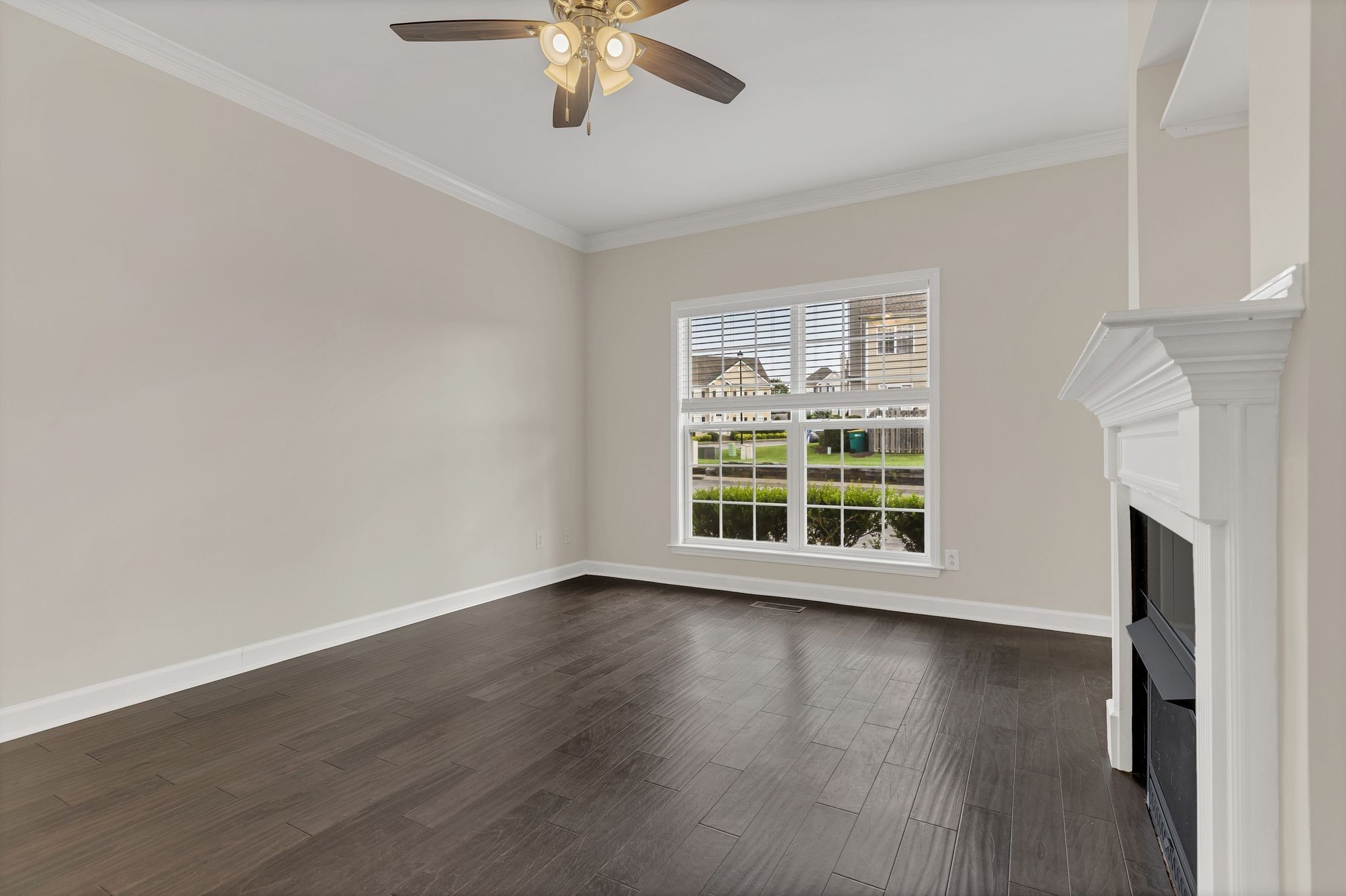 2271 Dewey Drive, Unit J3 Spring Hill, TN 37174 - Photo 7 of 31 a view of an empty room with wooden floor and a window