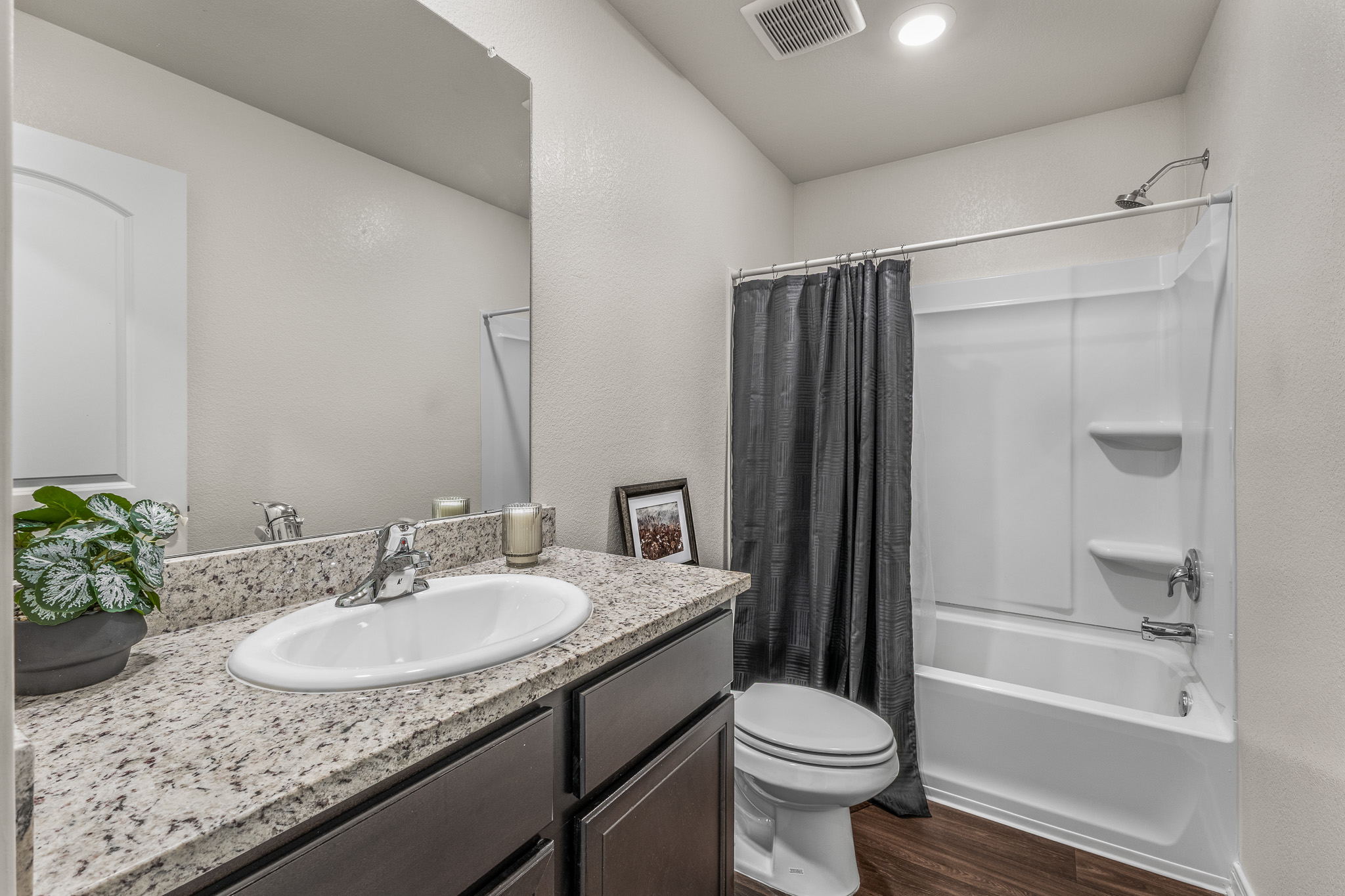 304 Hyacinth Way, Unit #7K Jarrell, TX 76537 - Photo 20 of 26 A well-appointed bathroom features a practical shower-tub combination and a vanity with granite counters.