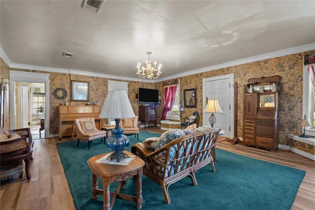 a living room with dining room and wooden floor