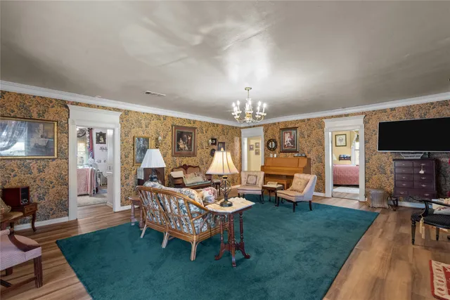 a living room with furniture a dining table and a fireplace