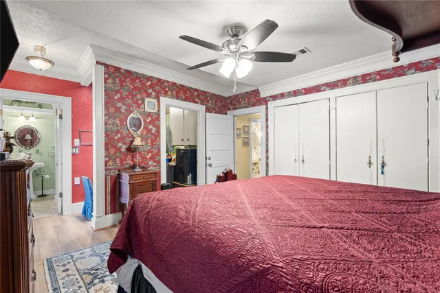 a bed room with a bed and a ceiling fan