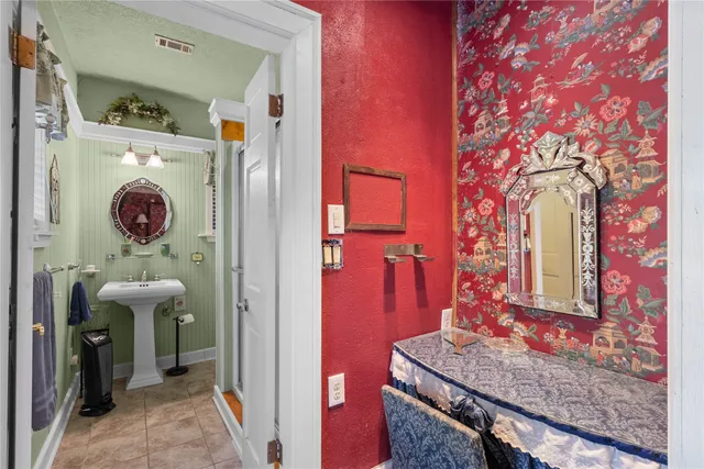 a bathroom with a sink a mirror and a window