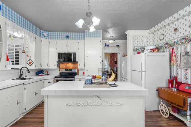 a kitchen with cabinets stainless steel appliances and a sink