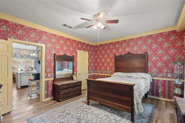 a bedroom with a bed and a chandelier