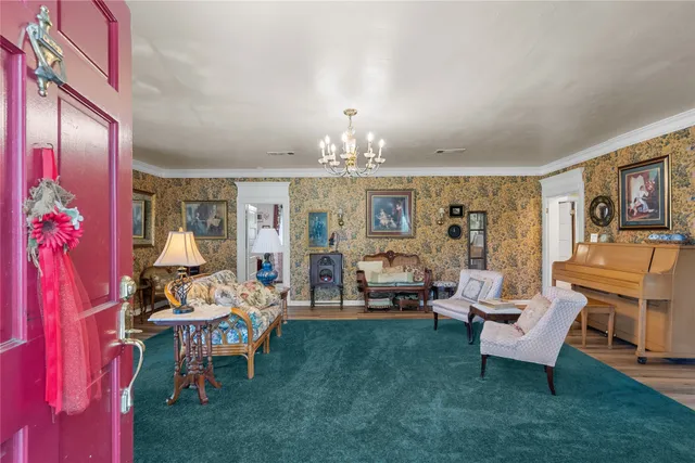 a living room with furniture and a chandelier