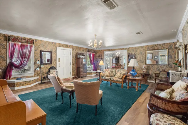 a living room with furniture and a chandelier