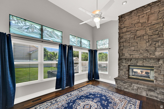 4792 Glasmann Way South Ogden, UT 84403 - Photo 39 of 70 Spacious living area featuring a floor-to-ceiling stone fireplace, high vaulted ceilings, and dark wood-finish flooring