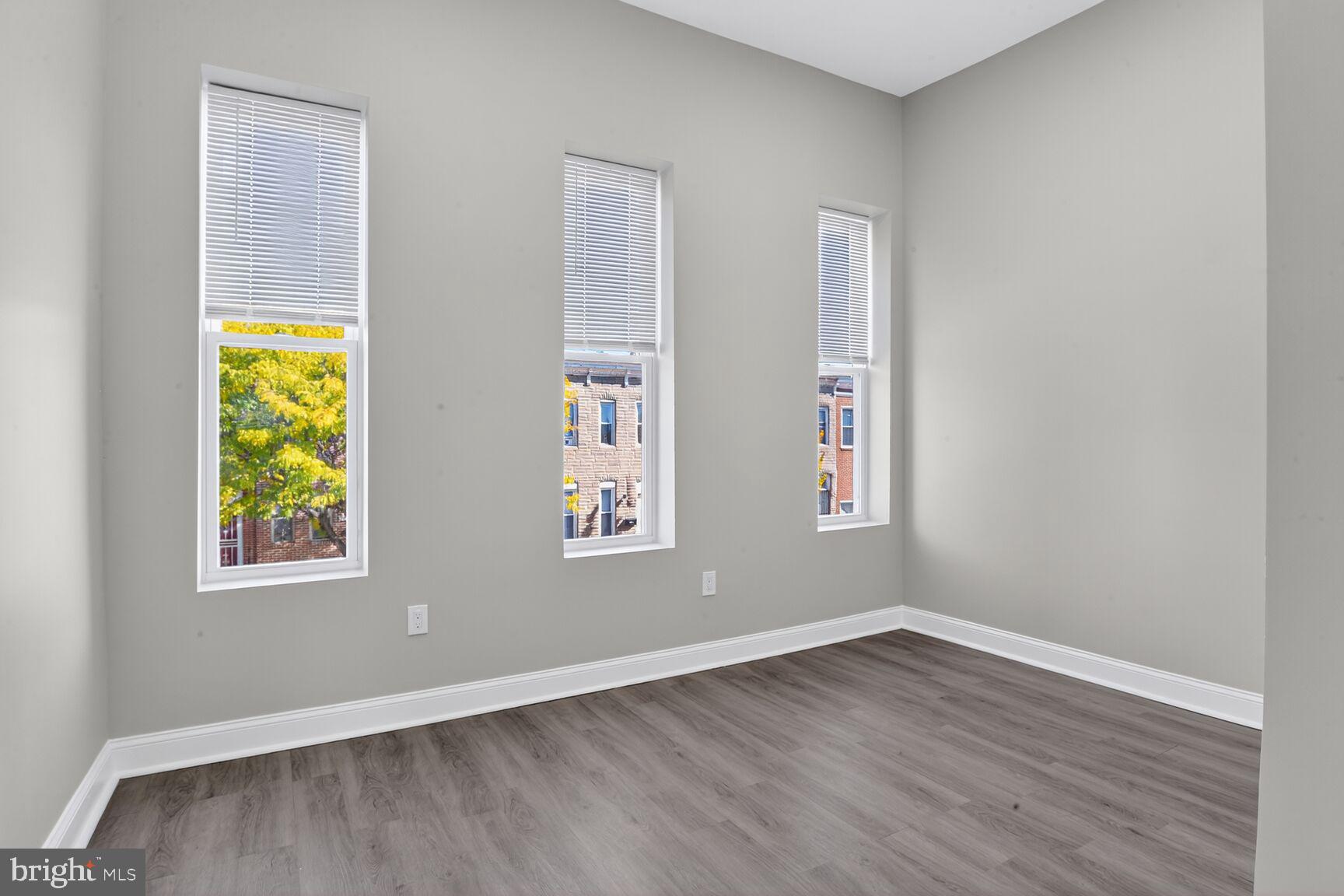 1108 South Carey Street Baltimore, MD 21223 - Photo 12 of 24 wooden floor in an empty room with a window