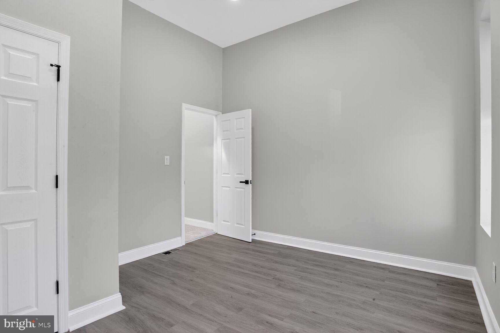 1108 South Carey Street Baltimore, MD 21223 - Photo 13 of 24 a view of an empty room with wooden floor