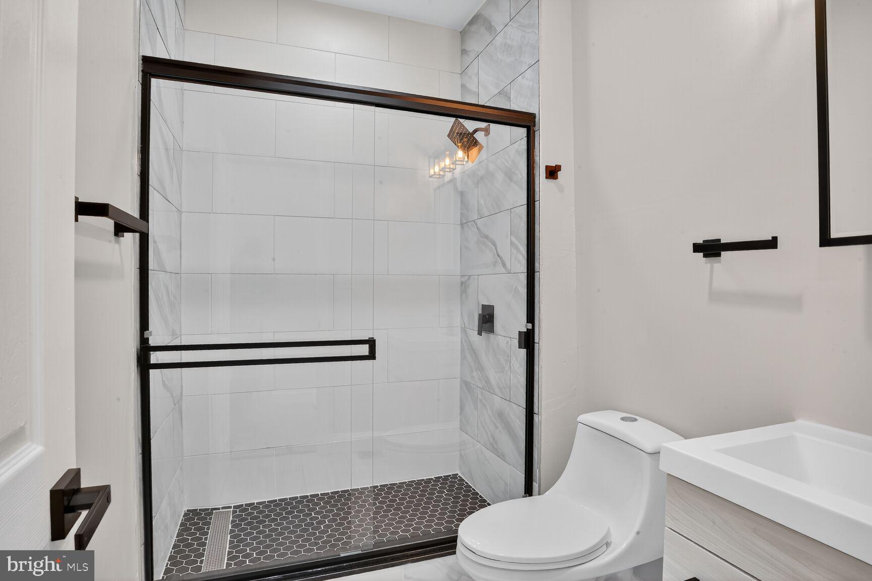 1108 South Carey Street Baltimore, MD 21223 - Photo 15 of 24 a white toilet sitting next to a bathroom sink