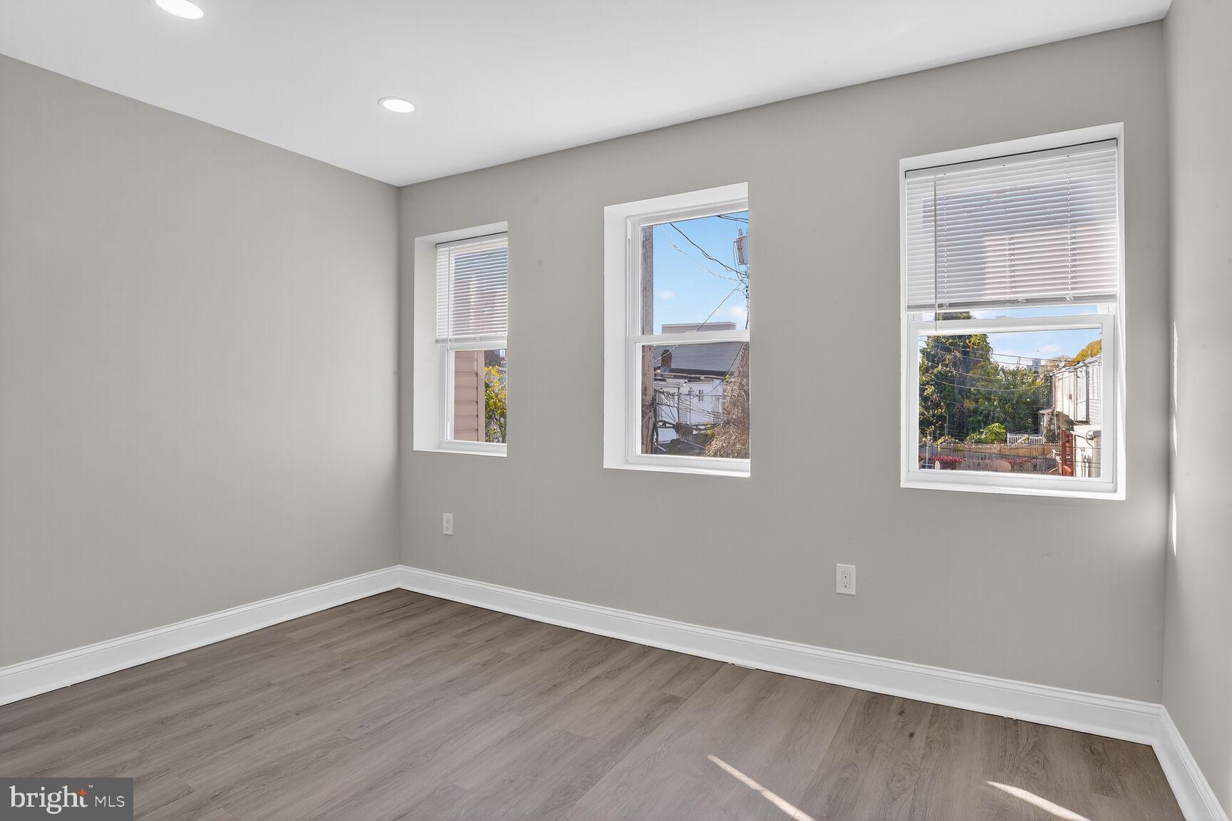 1108 South Carey Street Baltimore, MD 21223 - Photo 16 of 24 a view of an empty room with wooden floor and a window