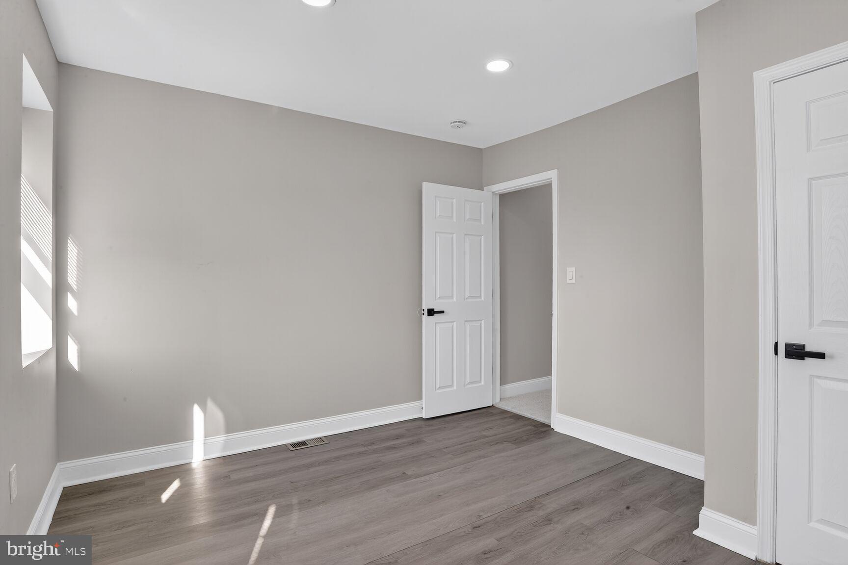 1108 South Carey Street Baltimore, MD 21223 - Photo 17 of 24 a view of empty room with wooden floor