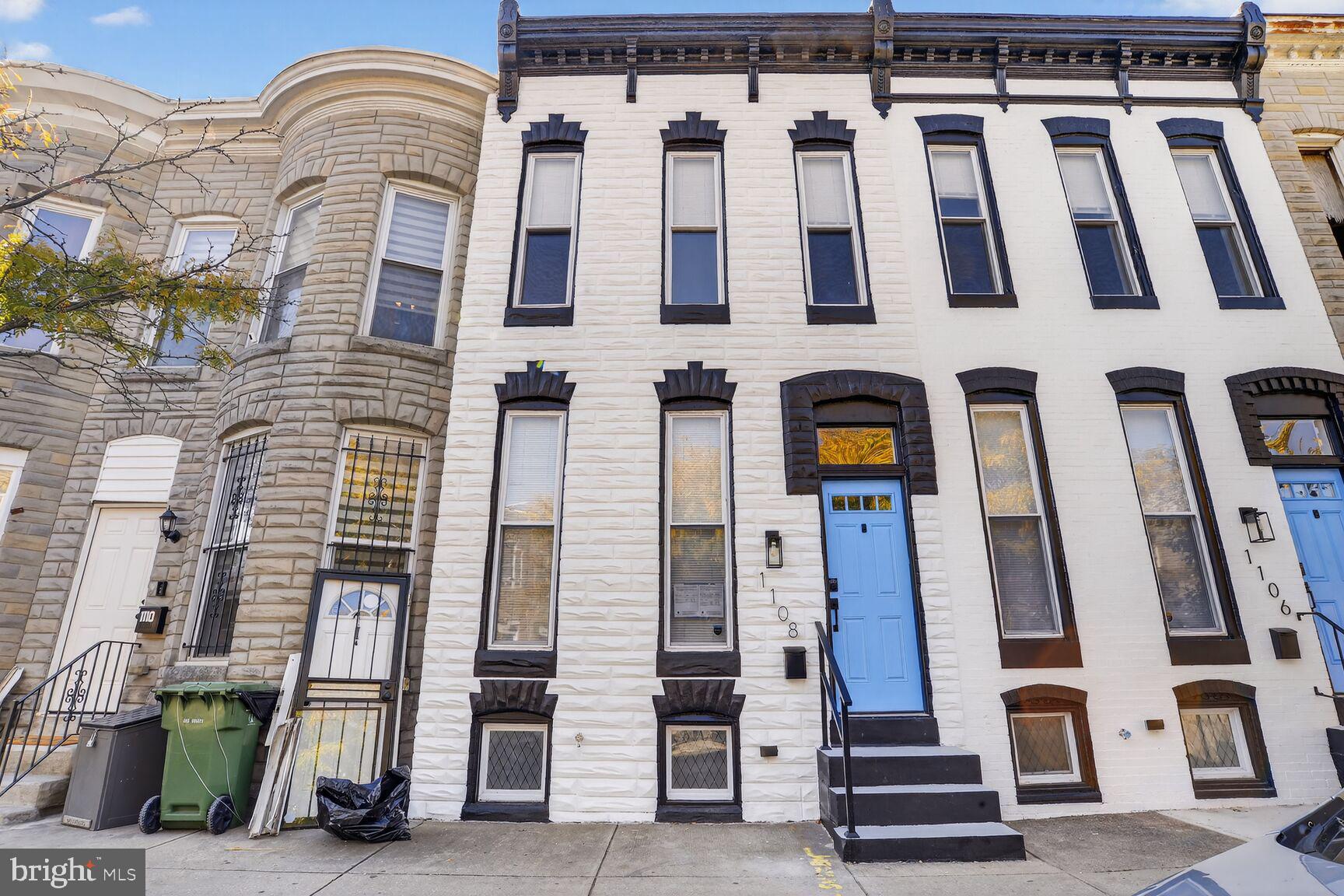 1108 South Carey Street Baltimore, MD 21223 - Photo 2 of 24 a front view of a building with many windows