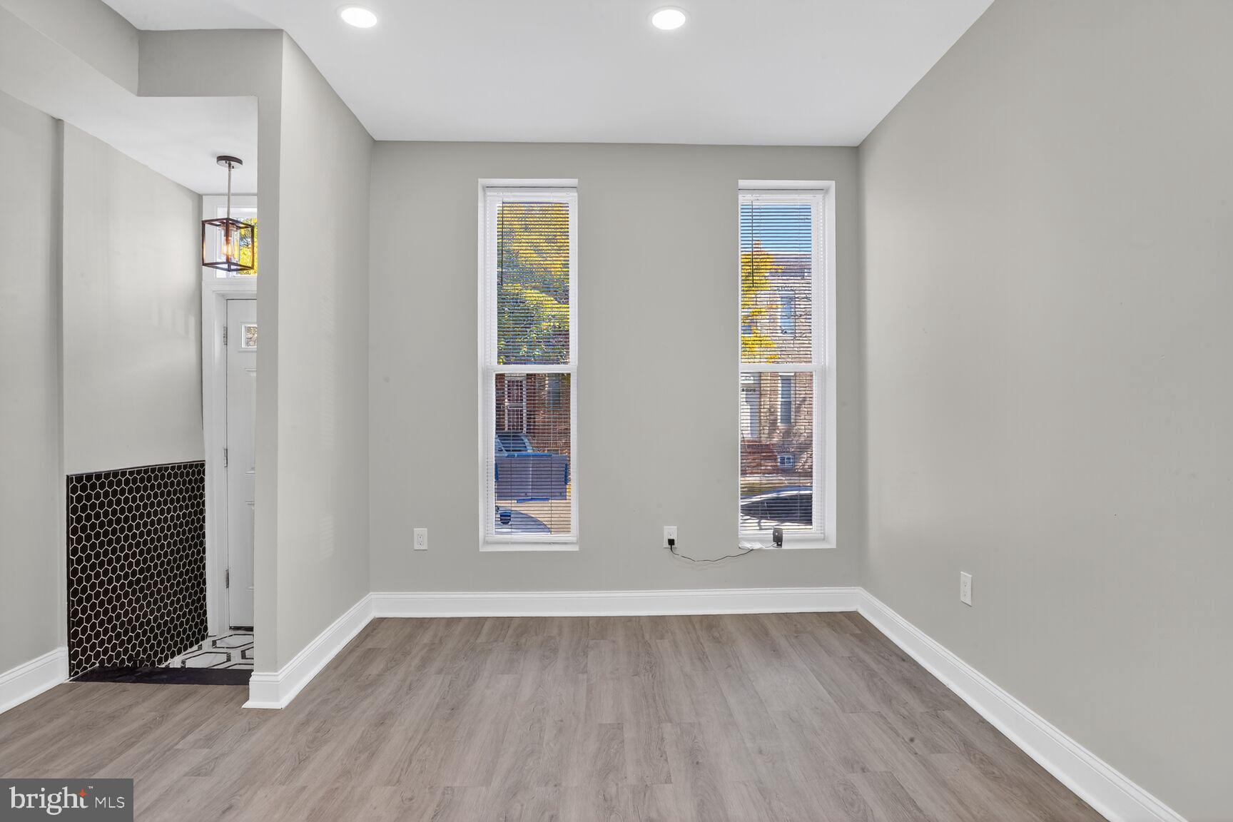 1108 South Carey Street Baltimore, MD 21223 - Photo 6 of 24 an empty room with wooden floor and windows