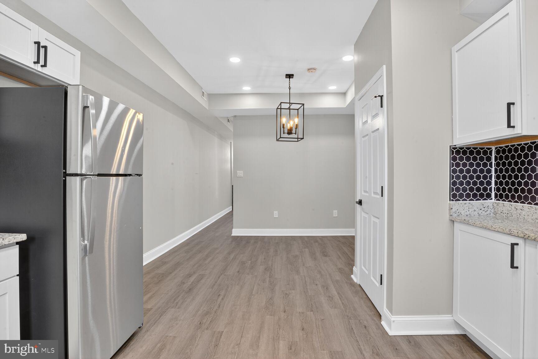 1108 South Carey Street Baltimore, MD 21223 - Photo 10 of 24 a view of hallway with wooden floor