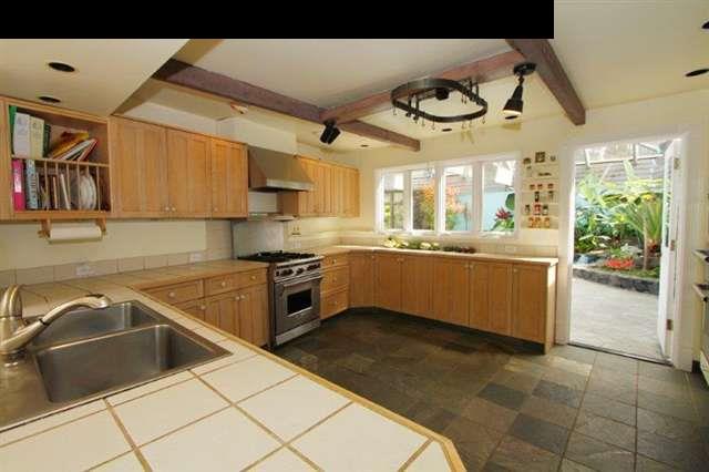 333 Middle Road Kula, HI 96790 - Photo 11 of 25 a kitchen with stainless steel appliances granite countertop a sink and a stove next to a window