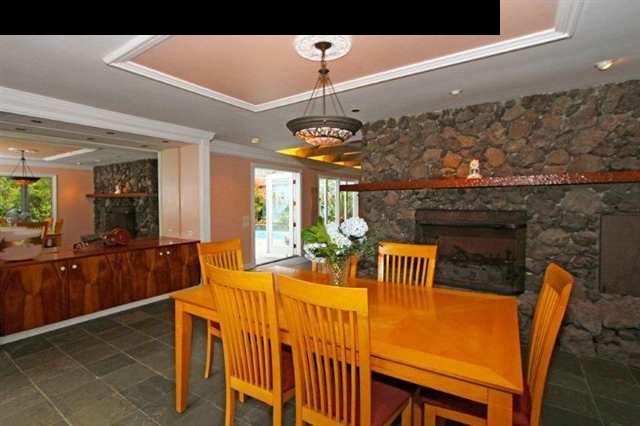 333 Middle Road Kula, HI 96790 - Photo 14 of 25 a dining room with furniture a chandelier a window and a fireplace