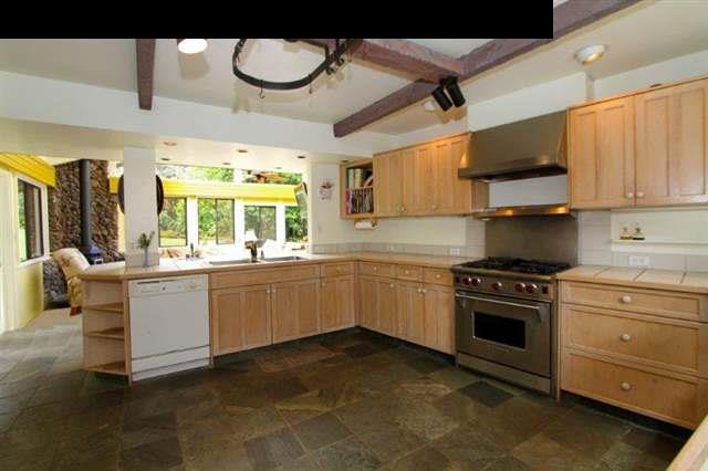 333 Middle Road Kula, HI 96790 - Photo 10 of 25 a kitchen with a stove window and cabinets