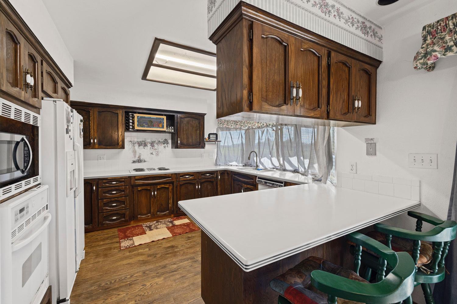 3270 Jackson Valley Road Ione, CA 95640 - Photo 11 of 34 a kitchen with stainless steel appliances a stove a sink and a refrigerator