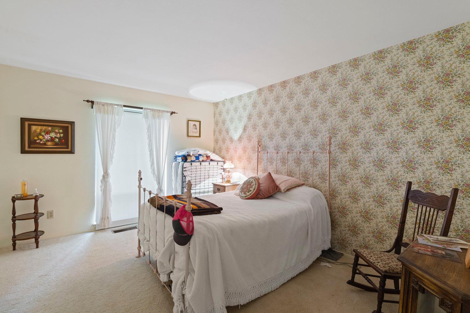 3270 Jackson Valley Road Ione, CA 95640 - Photo 15 of 34 a bedroom with a bed and a table in it