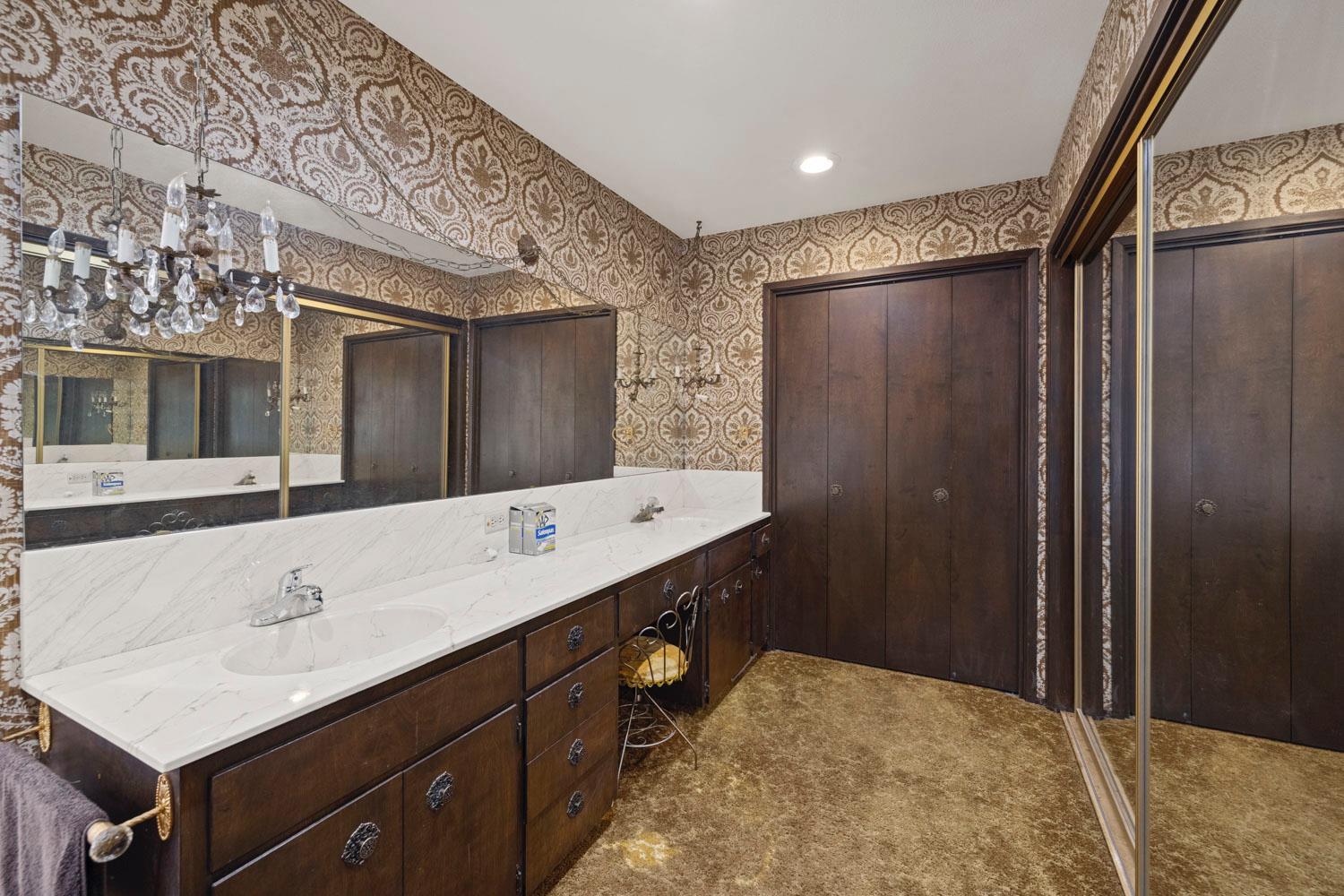 3270 Jackson Valley Road Ione, CA 95640 - Photo 20 of 34 a bathroom with a double vanity sink and mirror with shower