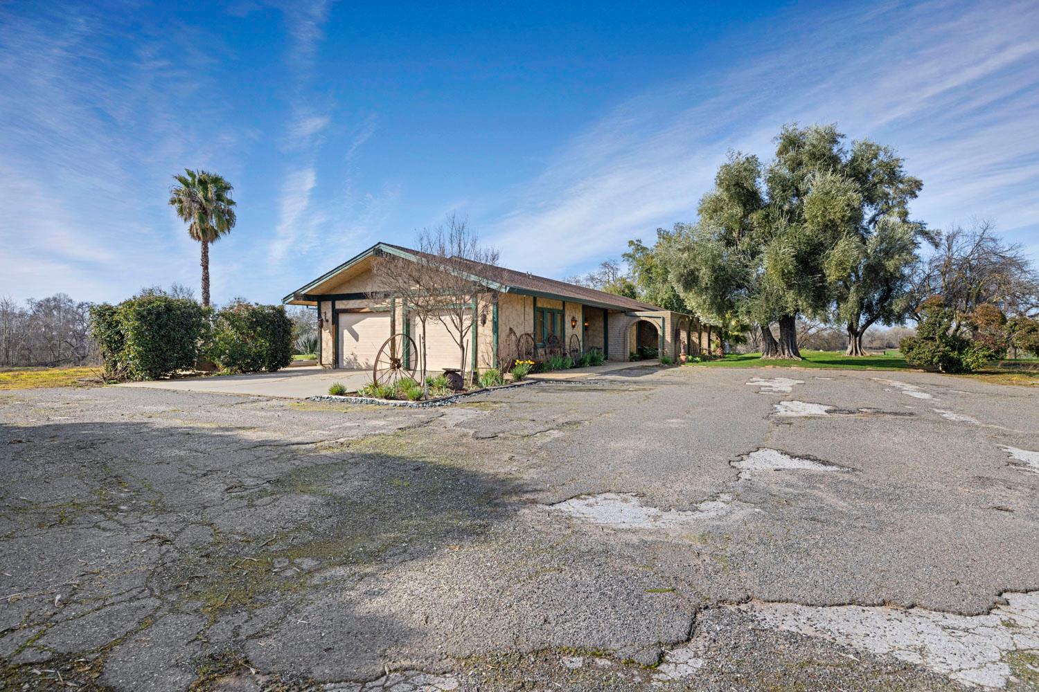 3270 Jackson Valley Road Ione, CA 95640 - Photo 33 of 34 a front view of a house with a yard and potted plants