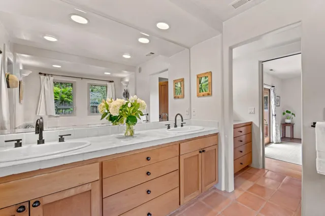 a bathroom with a double vanity sink and a with a mirror