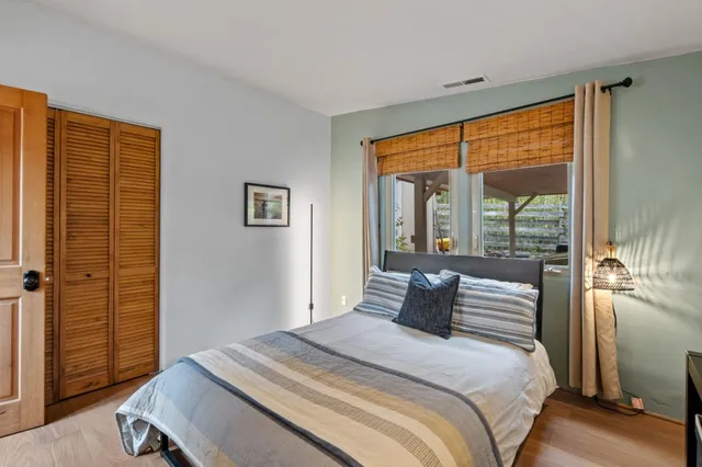 a bedroom with a large bed and a large window