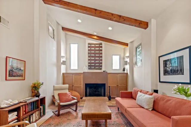 a living room with furniture fireplace and a window