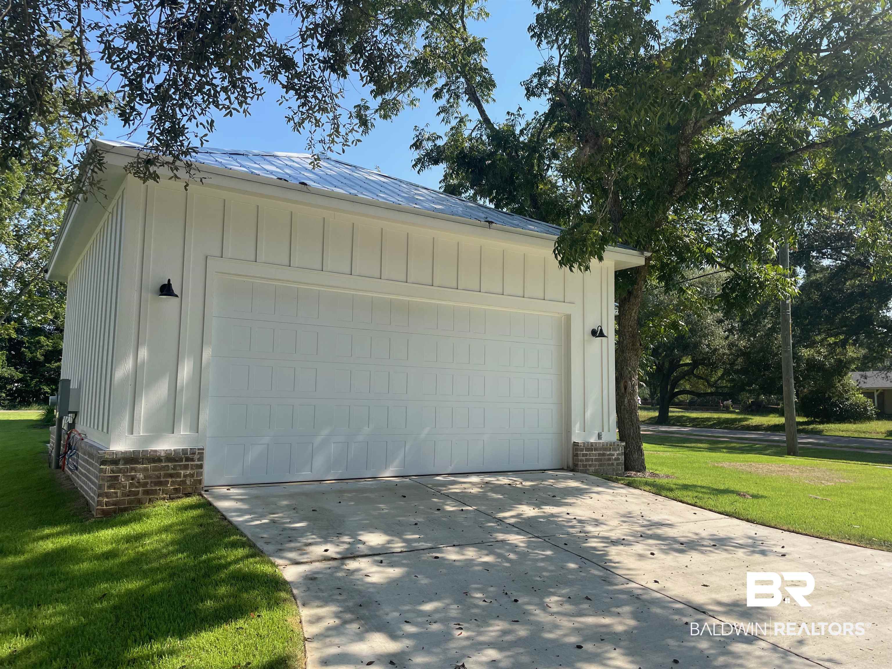 14710 Camelia Street Magnolia Springs, AL 36555 - Photo 15 of 23 Garage with a lawn
