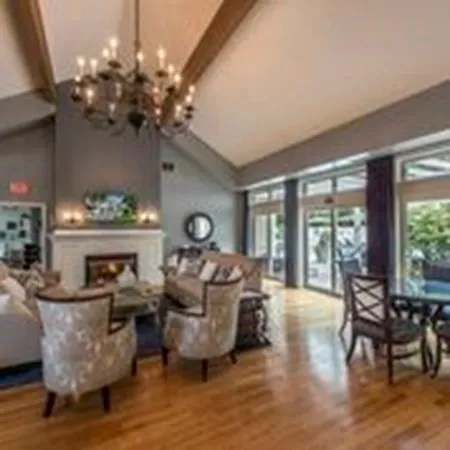 a living room with fireplace furniture and a large window