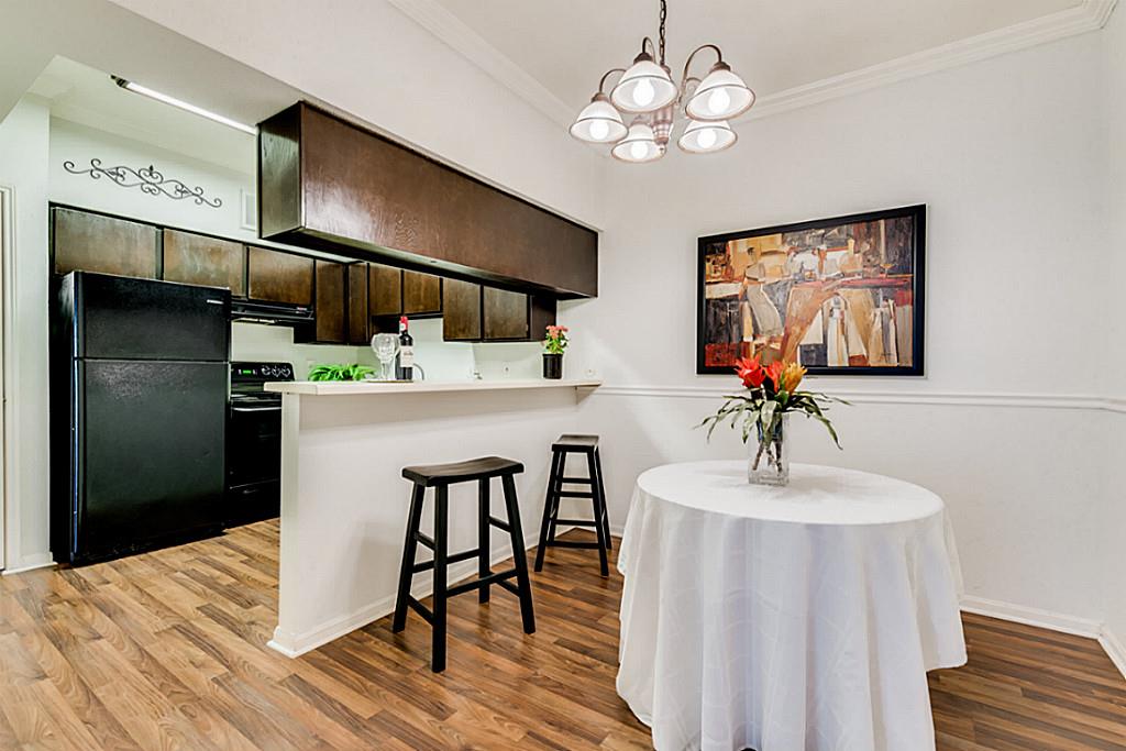 2100 Tanglewilde Street, Unit 296 Houston, TX 77063 - Photo 11 of 31 a dining room with wooden floor and chandelier