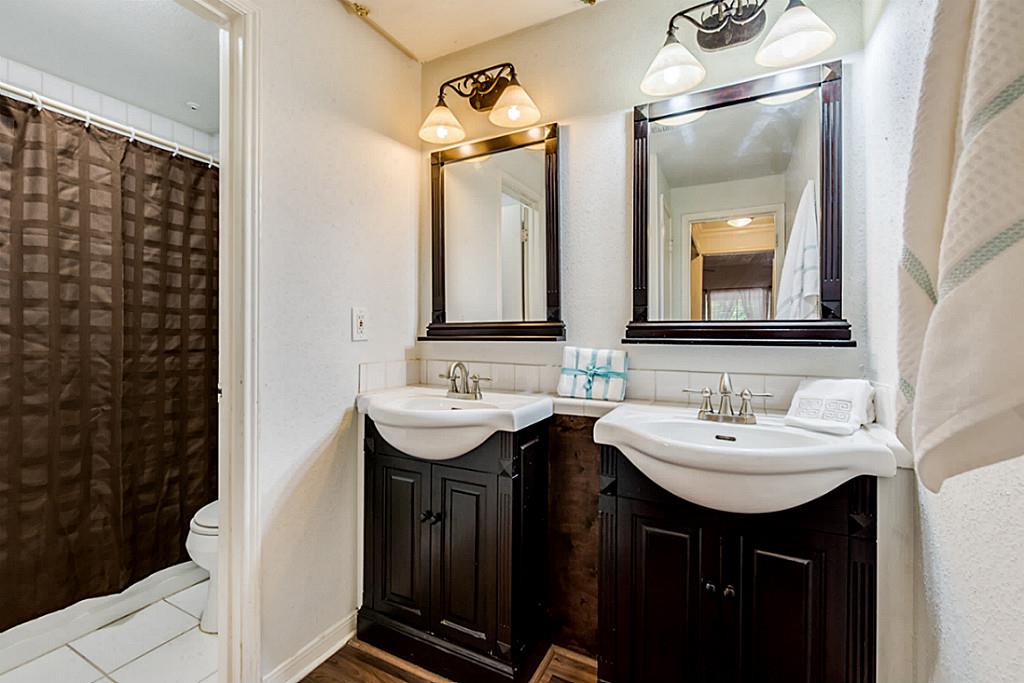 2100 Tanglewilde Street, Unit 296 Houston, TX 77063 - Photo 16 of 31 a bathroom with a double vanity sink and a mirror