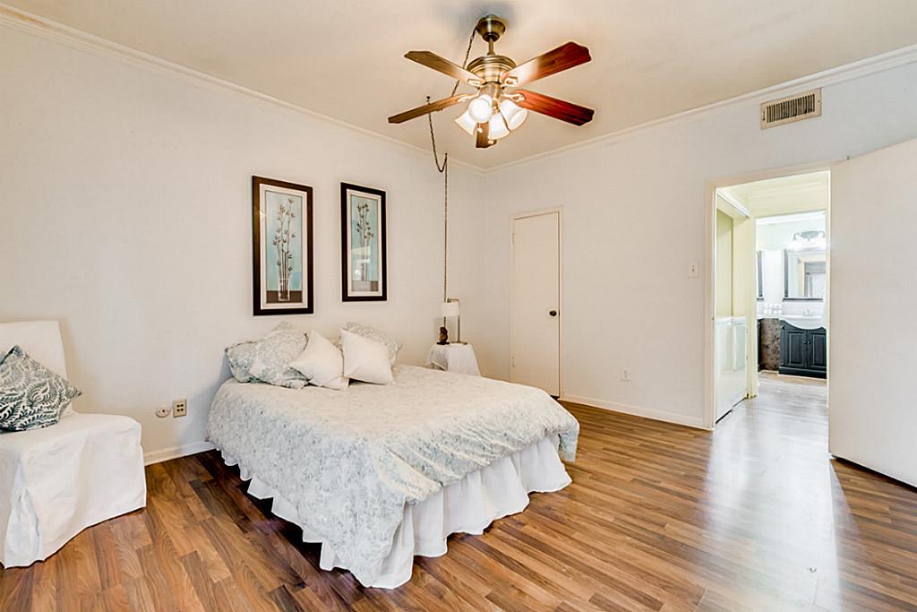 2100 Tanglewilde Street, Unit 296 Houston, TX 77063 - Photo 19 of 31 a bedroom with a bed and wooden floor