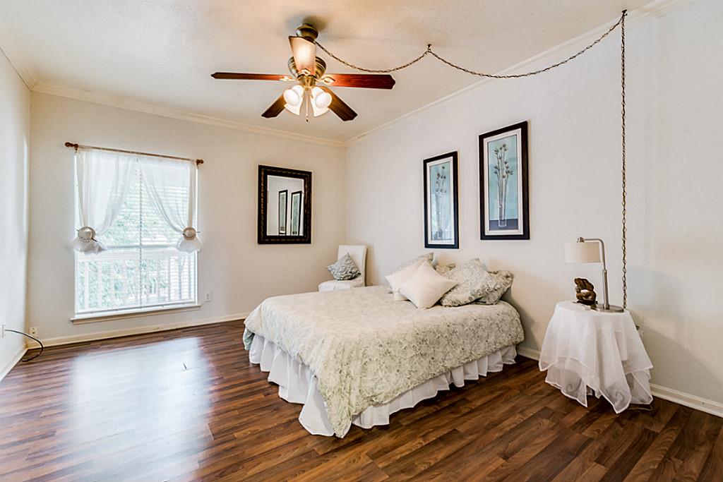 2100 Tanglewilde Street, Unit 296 Houston, TX 77063 - Photo 20 of 31 a bedroom with a bed and wooden floor