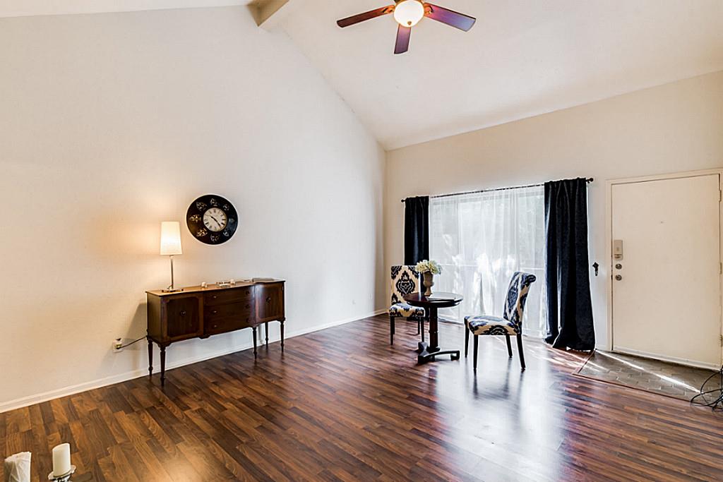 2100 Tanglewilde Street, Unit 296 Houston, TX 77063 - Photo 5 of 31 a dining room with wooden floor a glass table and chairs