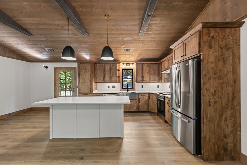 570 Cabin Trail Blue Ridge, GA 30513 - Photo 17 of 53 a kitchen with refrigerator cabinets and wooden floor