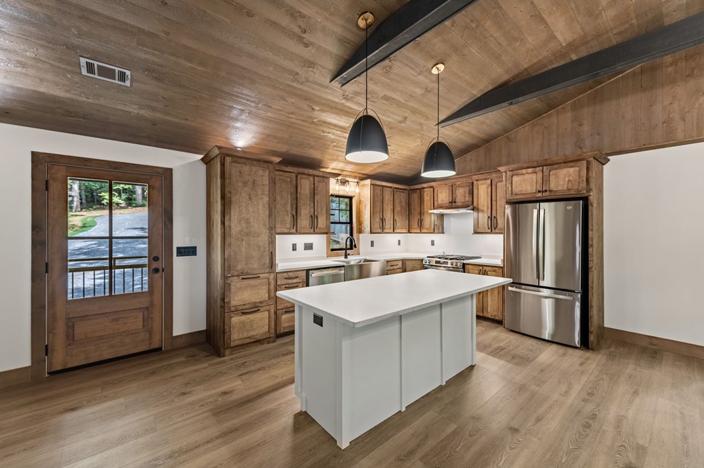 570 Cabin Trail Blue Ridge, GA 30513 - Photo 18 of 53 a kitchen with stainless steel appliances a stove a refrigerator and more cabinets